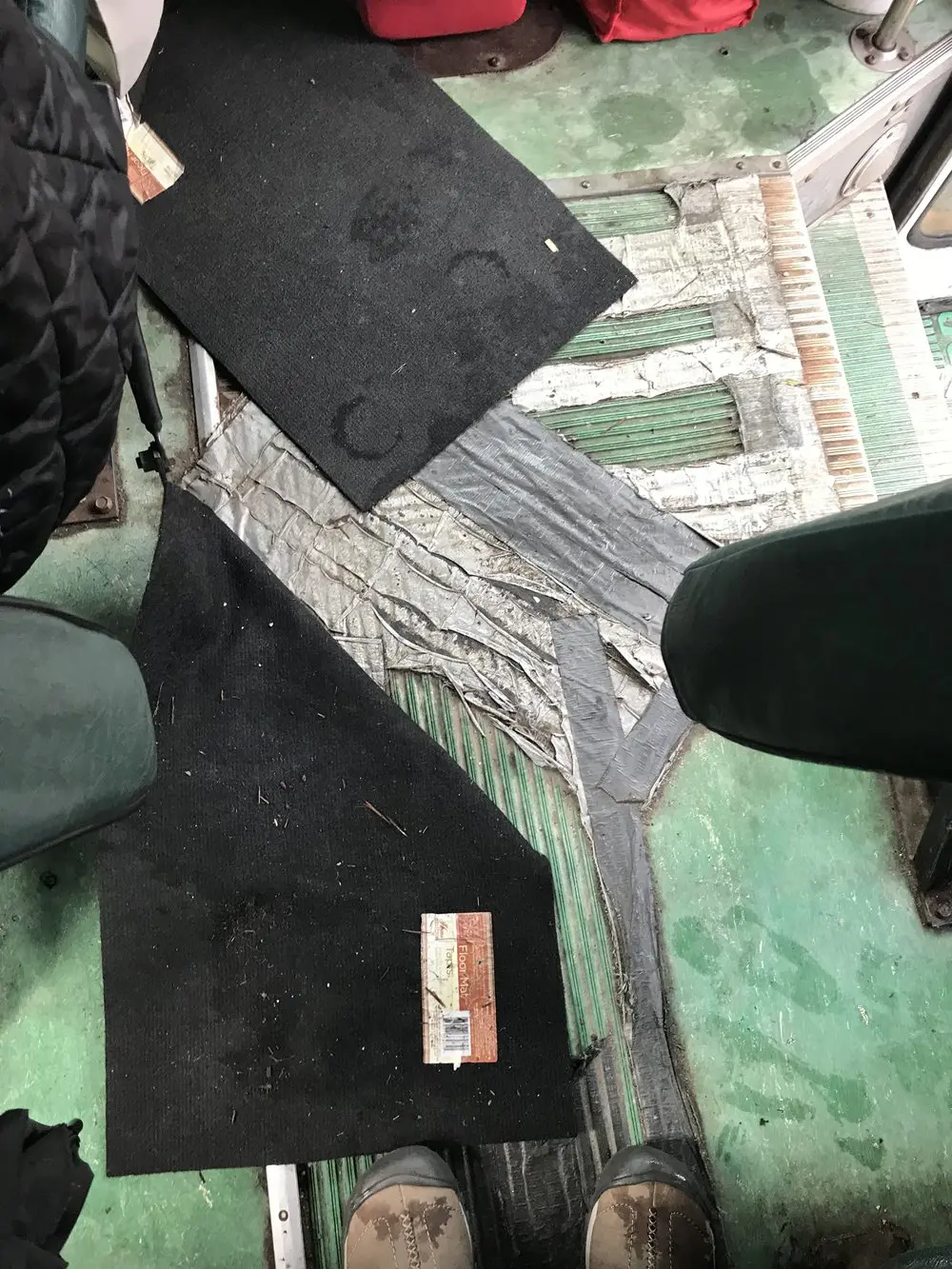 Here’s the floor of the aisle, if you can even call it a floor. Parts under the rubber mat and duct tape were rusted through.