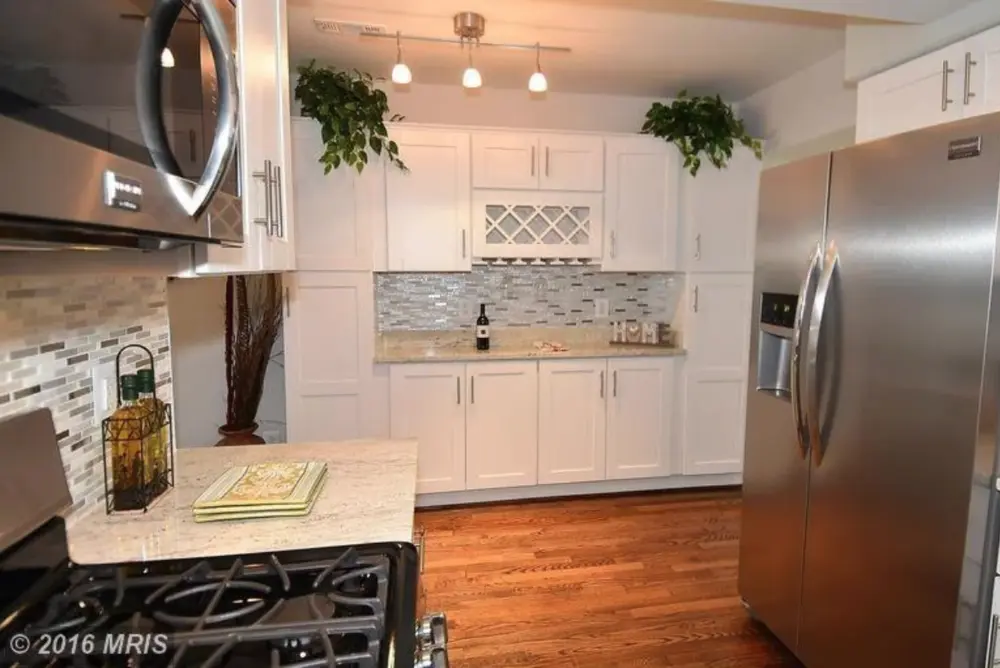 Photo by Chris Piller: Same kitchen as above, opposite wall space made into additional cabinet and storage space.